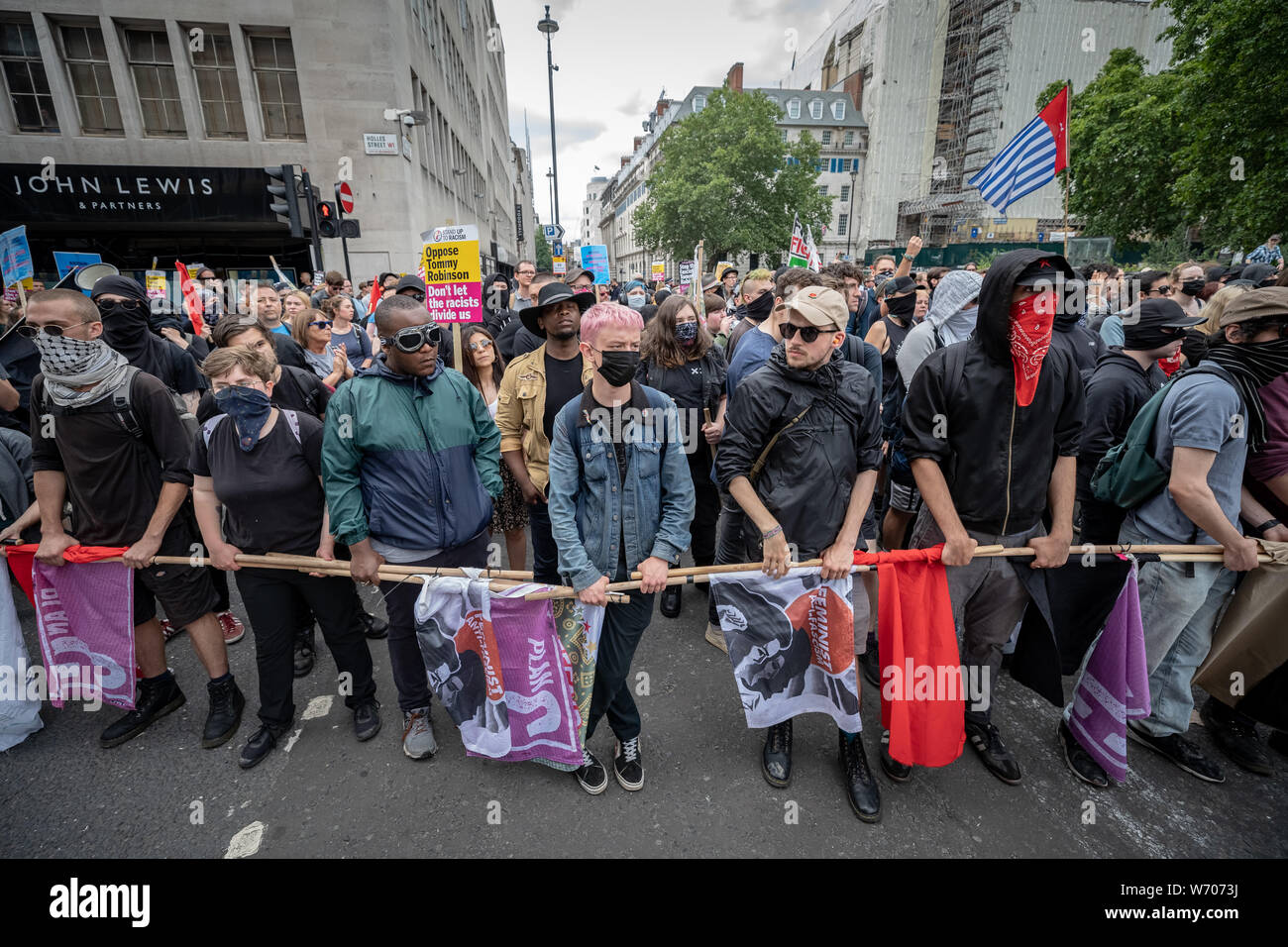 London, UK. 3rd August, 2019. Anti-fascists clash with police whilst counter-protesting the 'Free Tommy Robinson' demonstration. Police arrest twenty four during a mass demonstration in support of the jailed Tommy Robinson, real name Stephen Yaxley-Lennon, who was sentenced last month to nine months in prison after being found guilty in contempt of court. Counter-protesters including antifascist activists and the anti-racist group: Stand Up to Racism, opposed the pro-Robinson demonstrators with protest groups kept apart by met police. Credit: Guy Corbishley/Alamy Live News Stock Photo