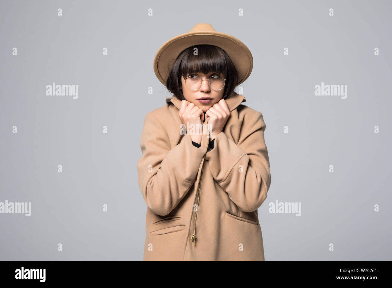 Portrait of girl get freeze wearing overcoat and hat isolated on white