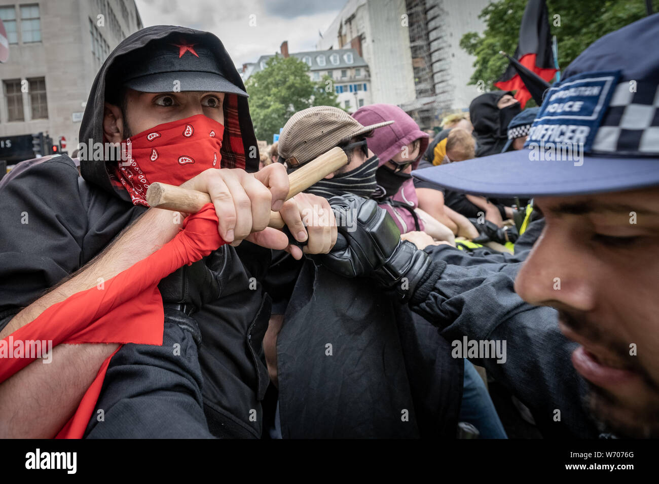 London, UK. 3rd August, 2019. Anti-fascists clash with police whilst counter-protesting the 'Free Tommy Robinson' demonstration. Police arrest twenty four during a mass demonstration in support of the jailed Tommy Robinson, real name Stephen Yaxley-Lennon, who was sentenced last month to nine months in prison after being found guilty in contempt of court. Counter-protesters including antifascist activists and the anti-racist group: Stand Up to Racism, opposed the pro-Robinson demonstrators with protest groups kept apart by met police. Credit: Guy Corbishley/Alamy Live News Stock Photo