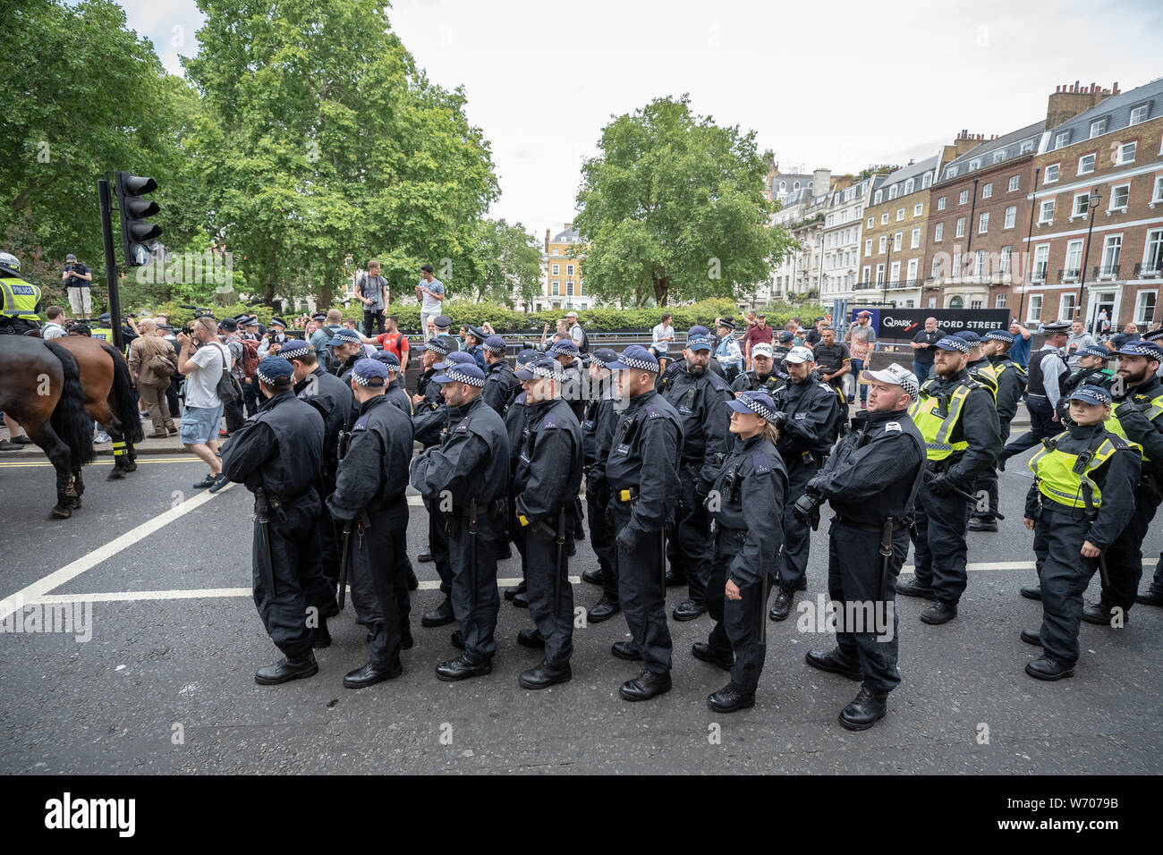 London, UK. 3rd August, 2019. Anti-fascists clash with police whilst counter-protesting the 'Free Tommy Robinson' demonstration. Police arrest twenty four during a mass demonstration in support of the jailed Tommy Robinson, real name Stephen Yaxley-Lennon, who was sentenced last month to nine months in prison after being found guilty in contempt of court. Counter-protesters including antifascist activists and the anti-racist group: Stand Up to Racism, opposed the pro-Robinson demonstrators with protest groups kept apart by met police. Credit: Guy Corbishley/Alamy Live News Stock Photo