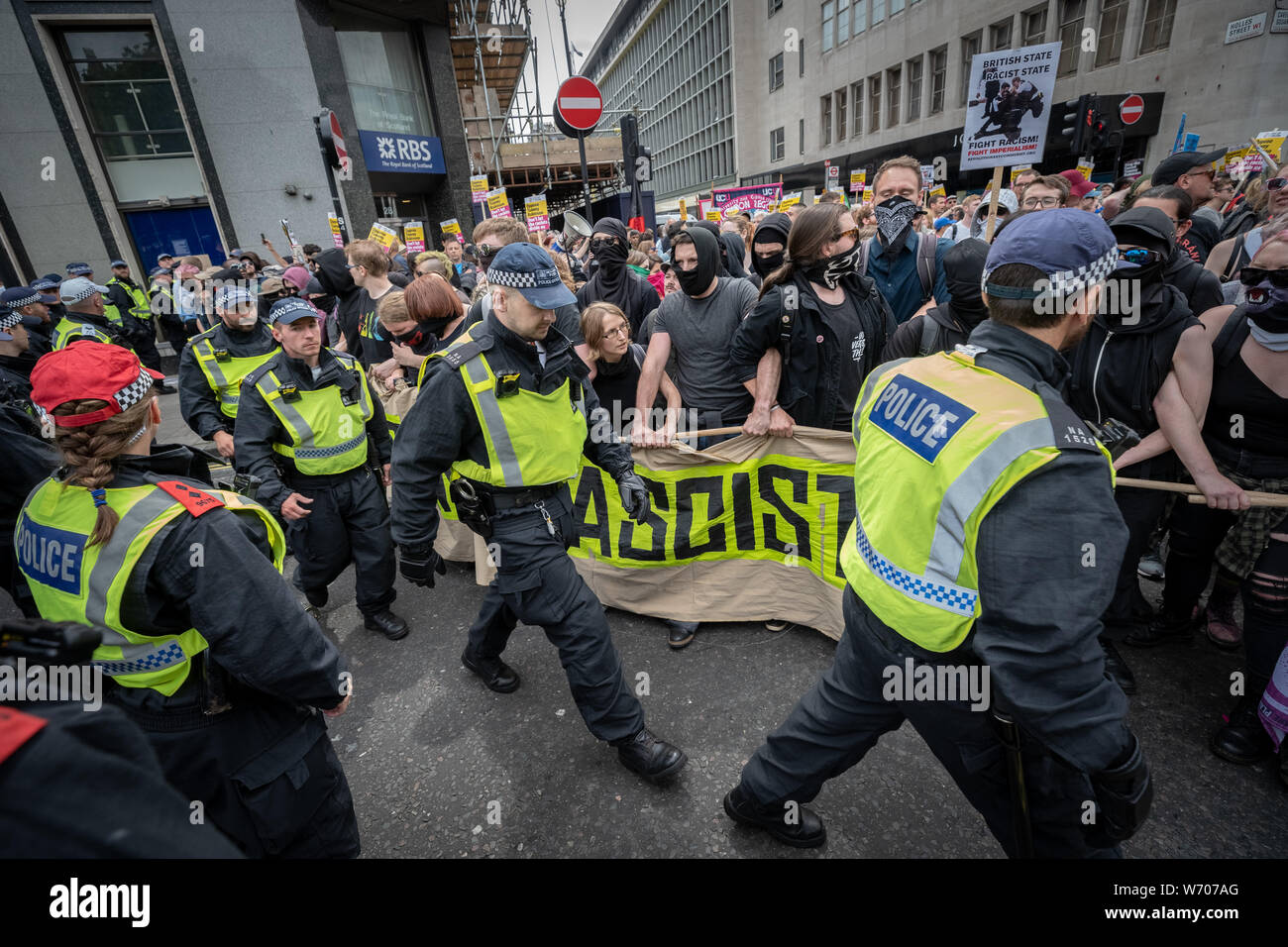 London, UK. 3rd August, 2019. Anti-fascists clash with police whilst counter-protesting the 'Free Tommy Robinson' demonstration. Police arrest twenty four during a mass demonstration in support of the jailed Tommy Robinson, real name Stephen Yaxley-Lennon, who was sentenced last month to nine months in prison after being found guilty in contempt of court. Counter-protesters including antifascist activists and the anti-racist group: Stand Up to Racism, opposed the pro-Robinson demonstrators with protest groups kept apart by met police. Credit: Guy Corbishley/Alamy Live News Stock Photo