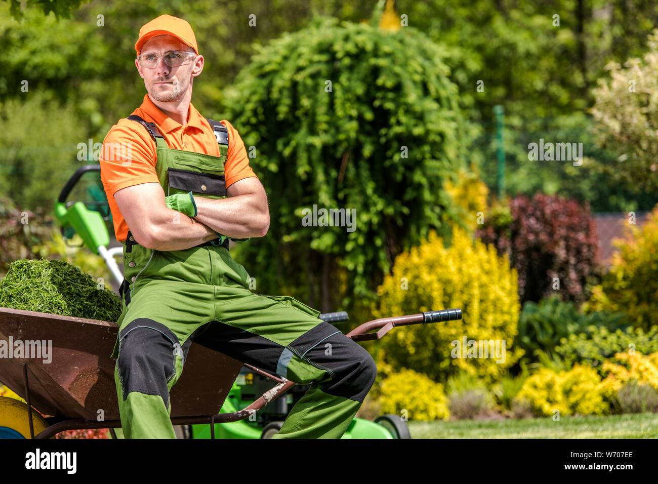 Professional Gardener Job. Satisfied Caucasian Garden Worker in His 30s Relaxing During Mid Day Work Break. Landscaping Industry. Stock Photo