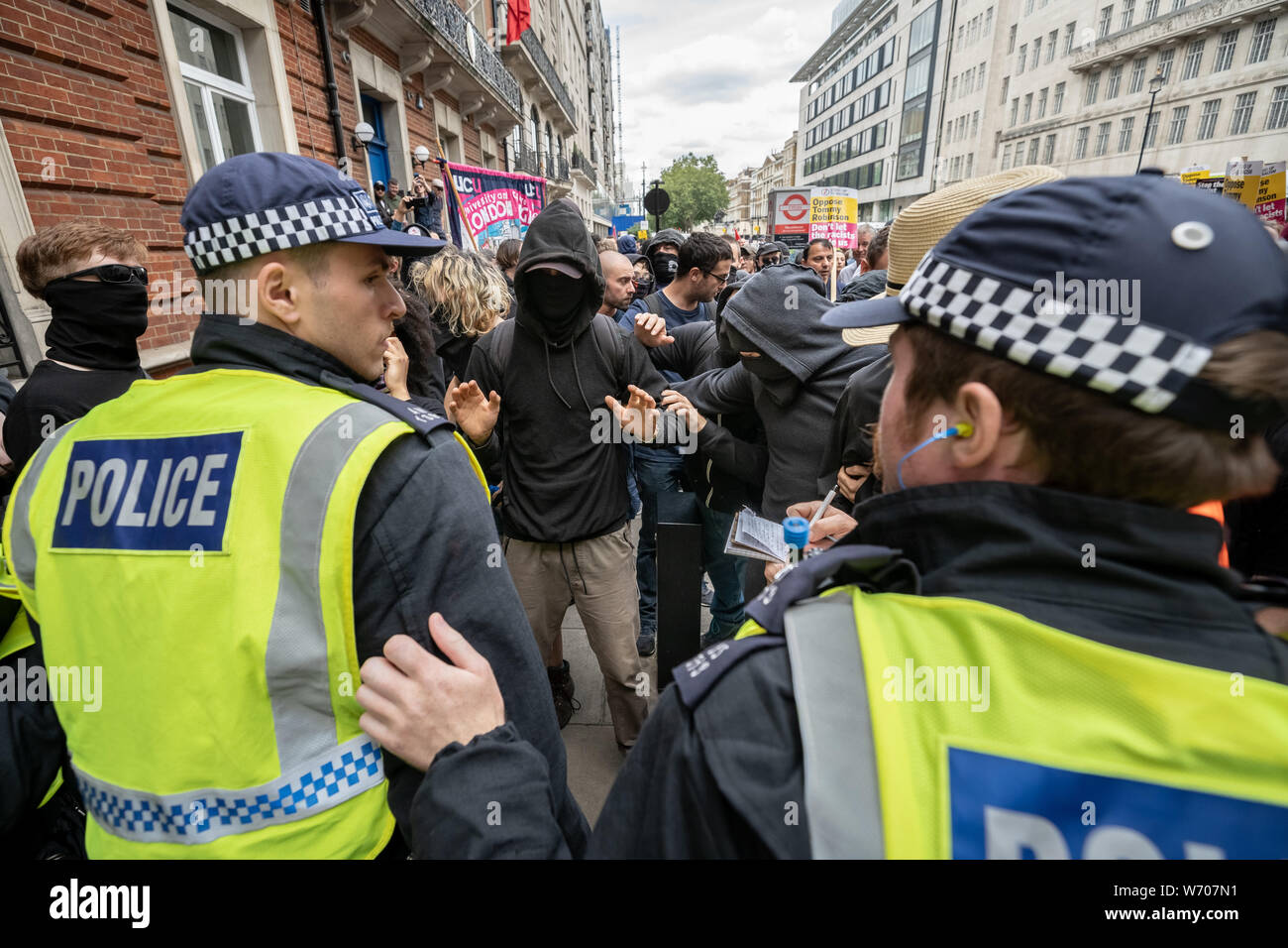 London, UK. 3rd August, 2019. Anti-fascists clash with police whilst counter-protesting the 'Free Tommy Robinson' demonstration. Police arrest twenty four during a mass demonstration in support of the jailed Tommy Robinson, real name Stephen Yaxley-Lennon, who was sentenced last month to nine months in prison after being found guilty in contempt of court. Counter-protesters including antifascist activists and the anti-racist group: Stand Up to Racism, opposed the pro-Robinson demonstrators with protest groups kept apart by met police. Credit: Guy Corbishley/Alamy Live News Stock Photo