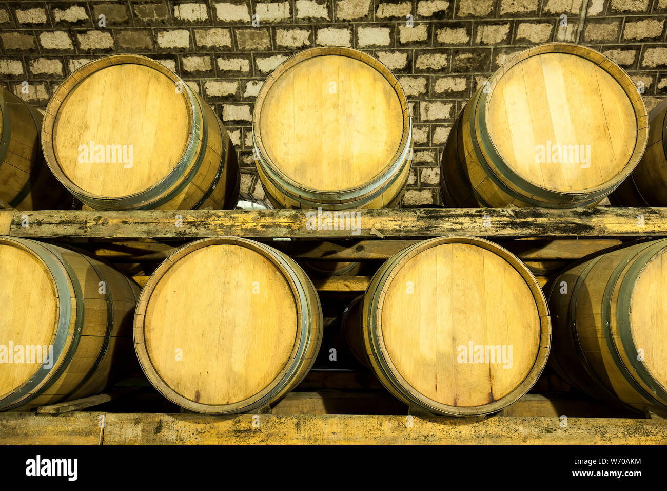 Wine barrels stacked in the cellar of the winery Stock Photo - Alamy