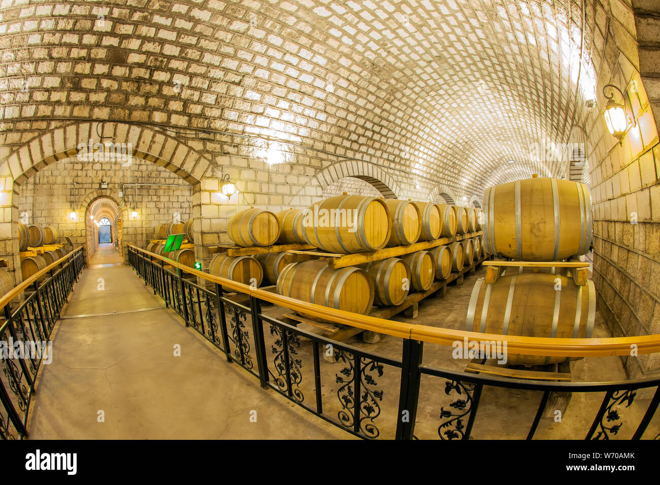 Wine barrels stacked in the cellar of the winery Stock Photo - Alamy