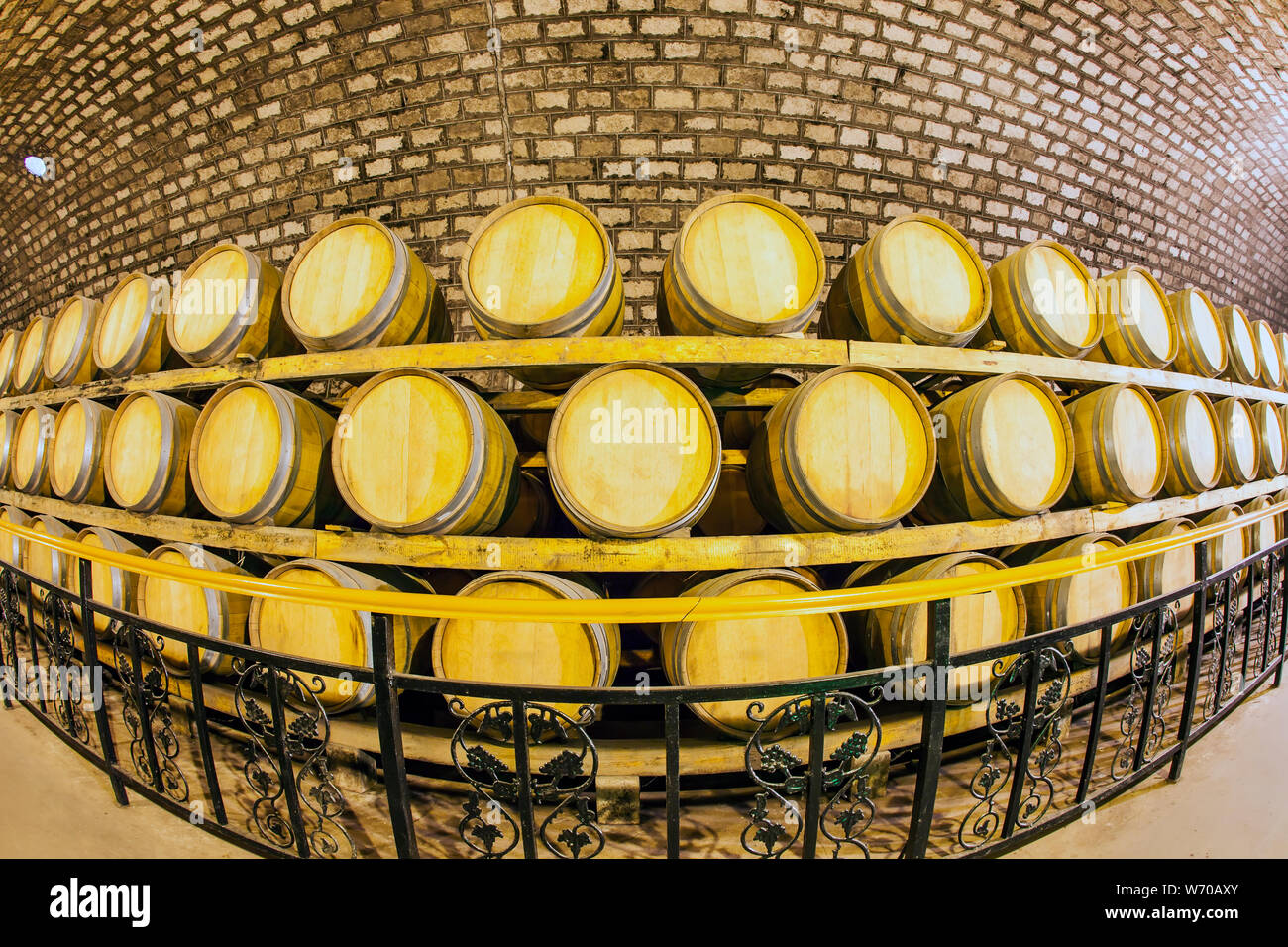 Wine barrels stacked in the cellar of the winery Stock Photo - Alamy