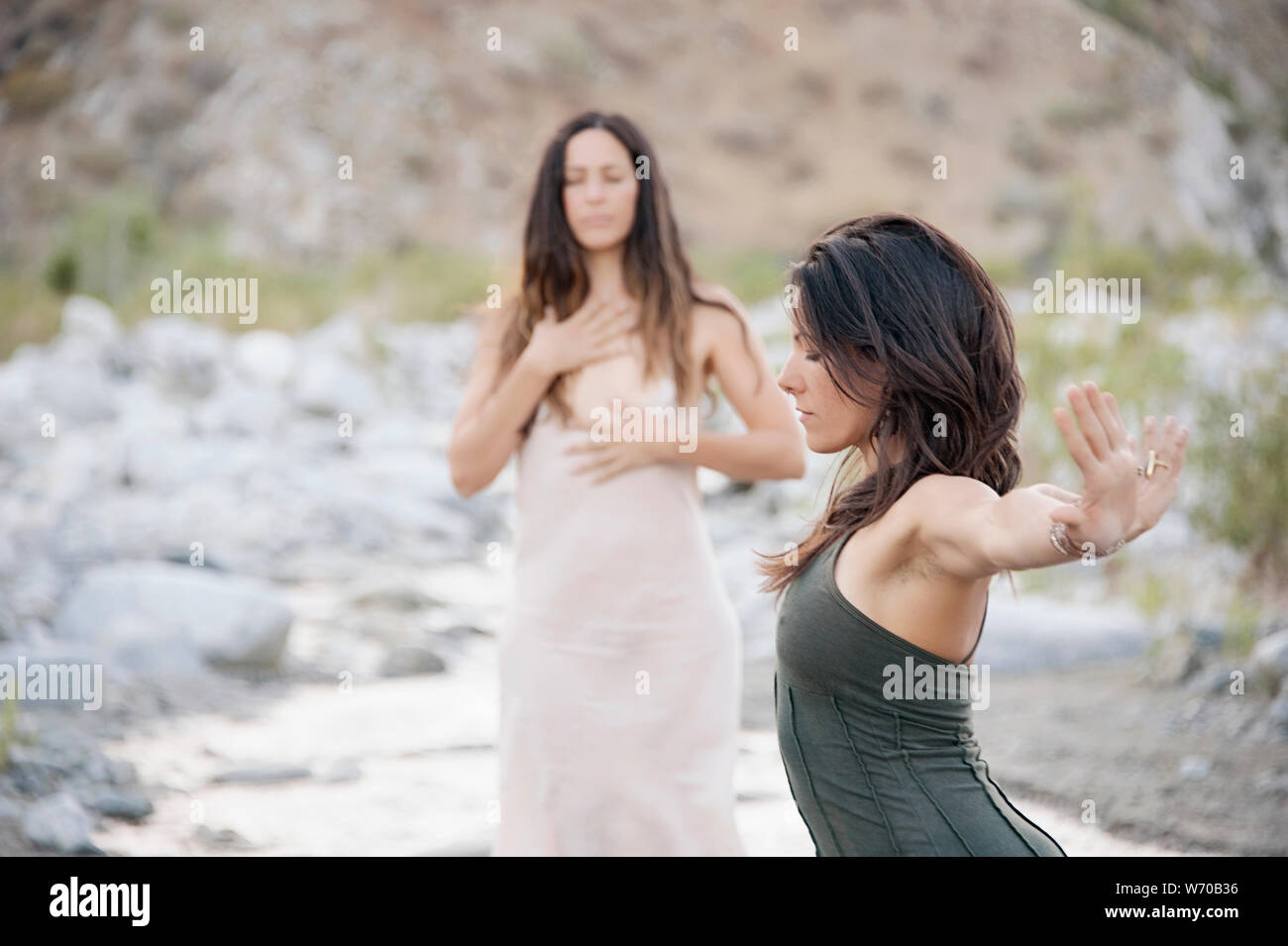 Beautiful wild women dancing freely with the desert river. Stock Photo