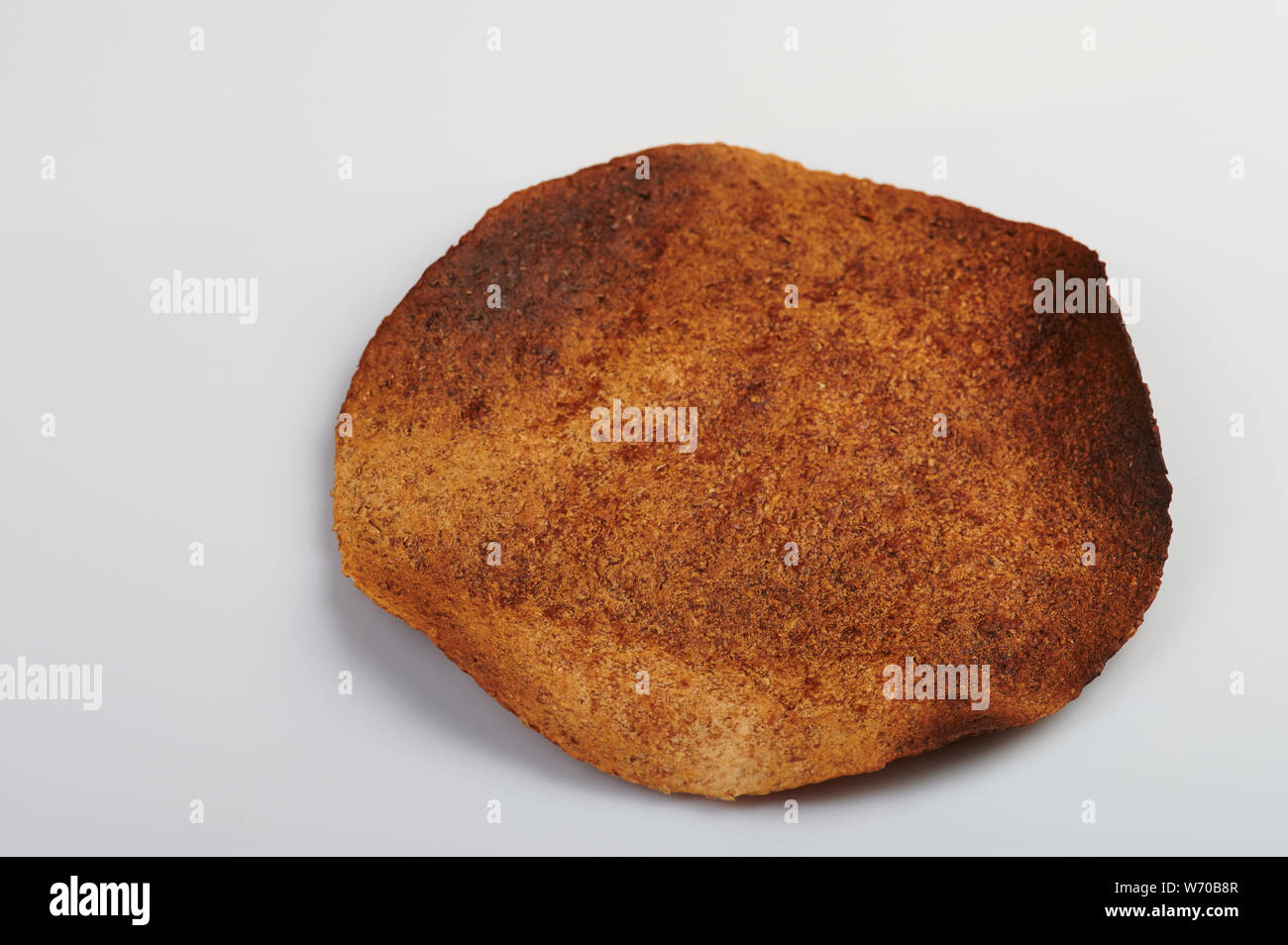 Burned brown tortilla angle view isolated on white background Stock ...