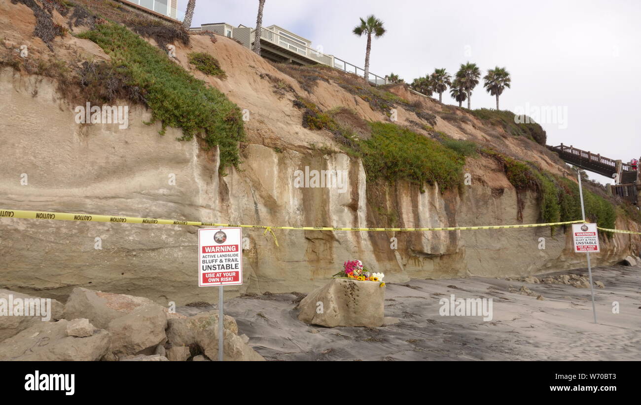 Warning signs and caution tape keep people from unstable cliffs at Grandview Beach in Encinitas, CA - site of a deadly bluff collapse. Stock Photo