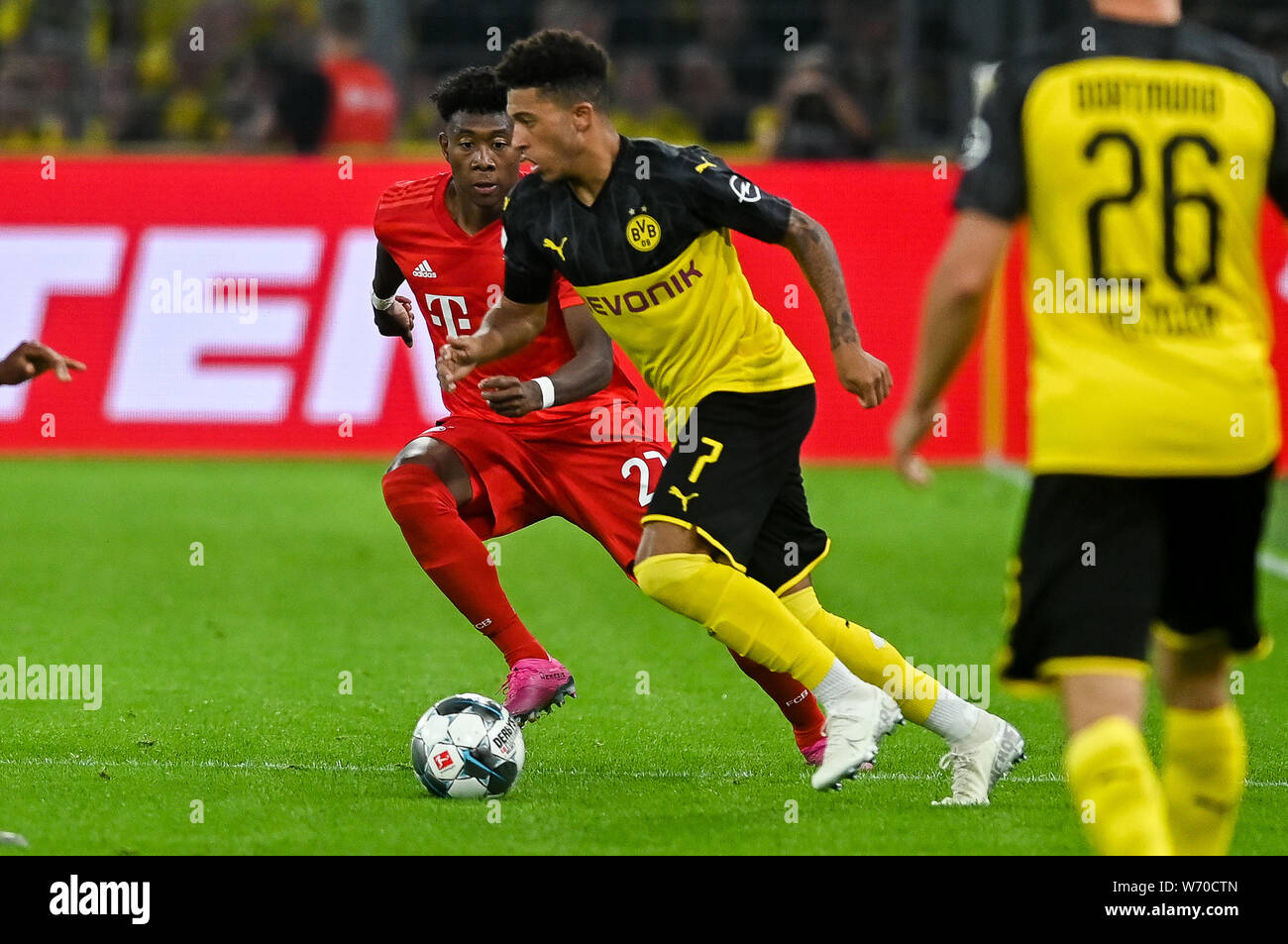 David Alaba from Bayern Munich (L) and Jadon Sancho from Borussia Dortmund (R) seen in action during the Germany Supercup Final 2019 match between Borussia Dortmund and Bayern Munich.(Final score: Borussia Dortmund 2:0 Bayern Munich) Stock Photo