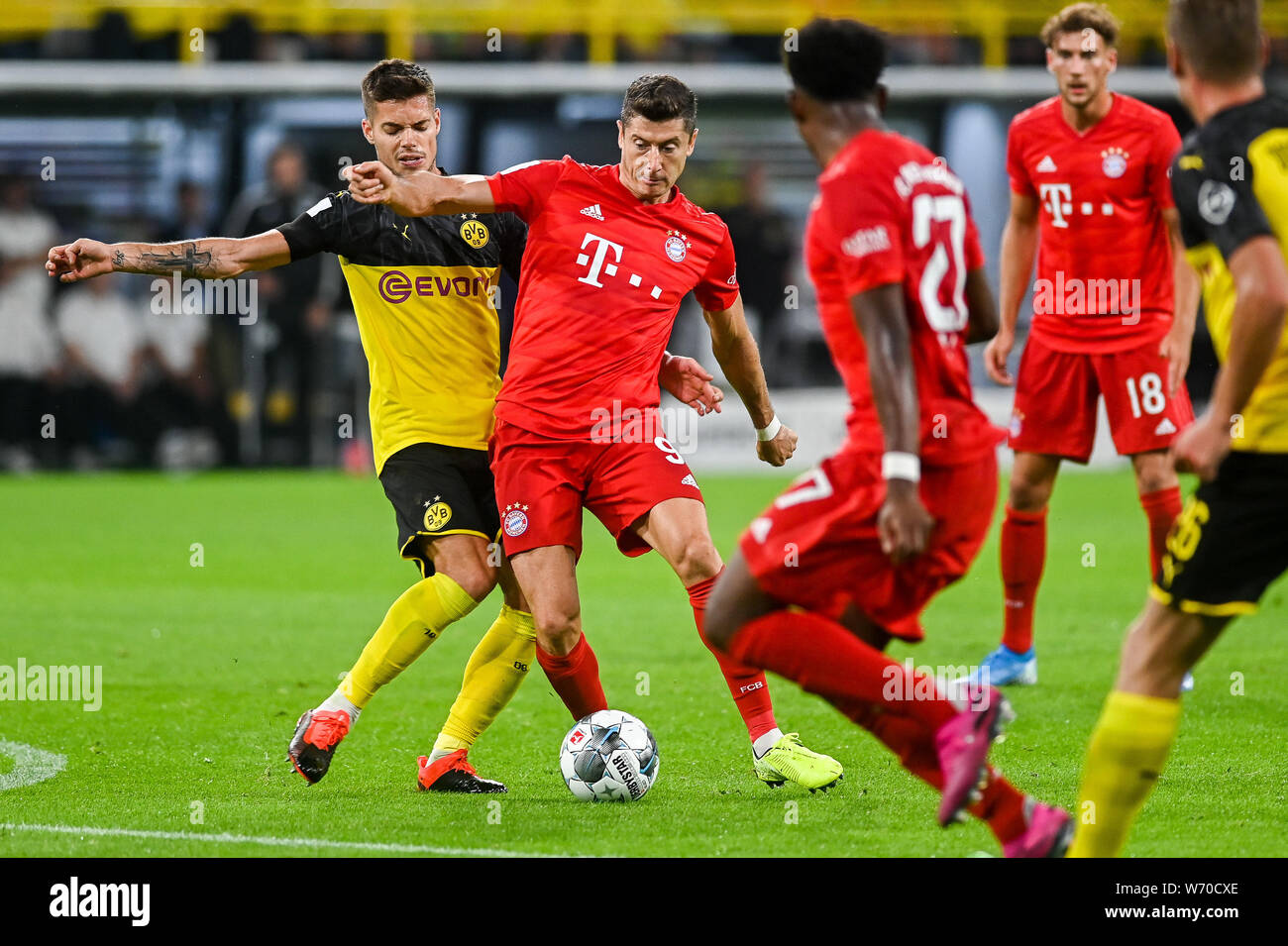 Julian Weigl from Borussia Dortmund (L) and Robert Lewandowski from Bayern Munich (R) are seen in action during the Germany Supercup Final 2019 match between Borussia Dortmund and Bayern Munich.(Final score: Borussia Dortmund 2:0 Bayern Munich) Stock Photo