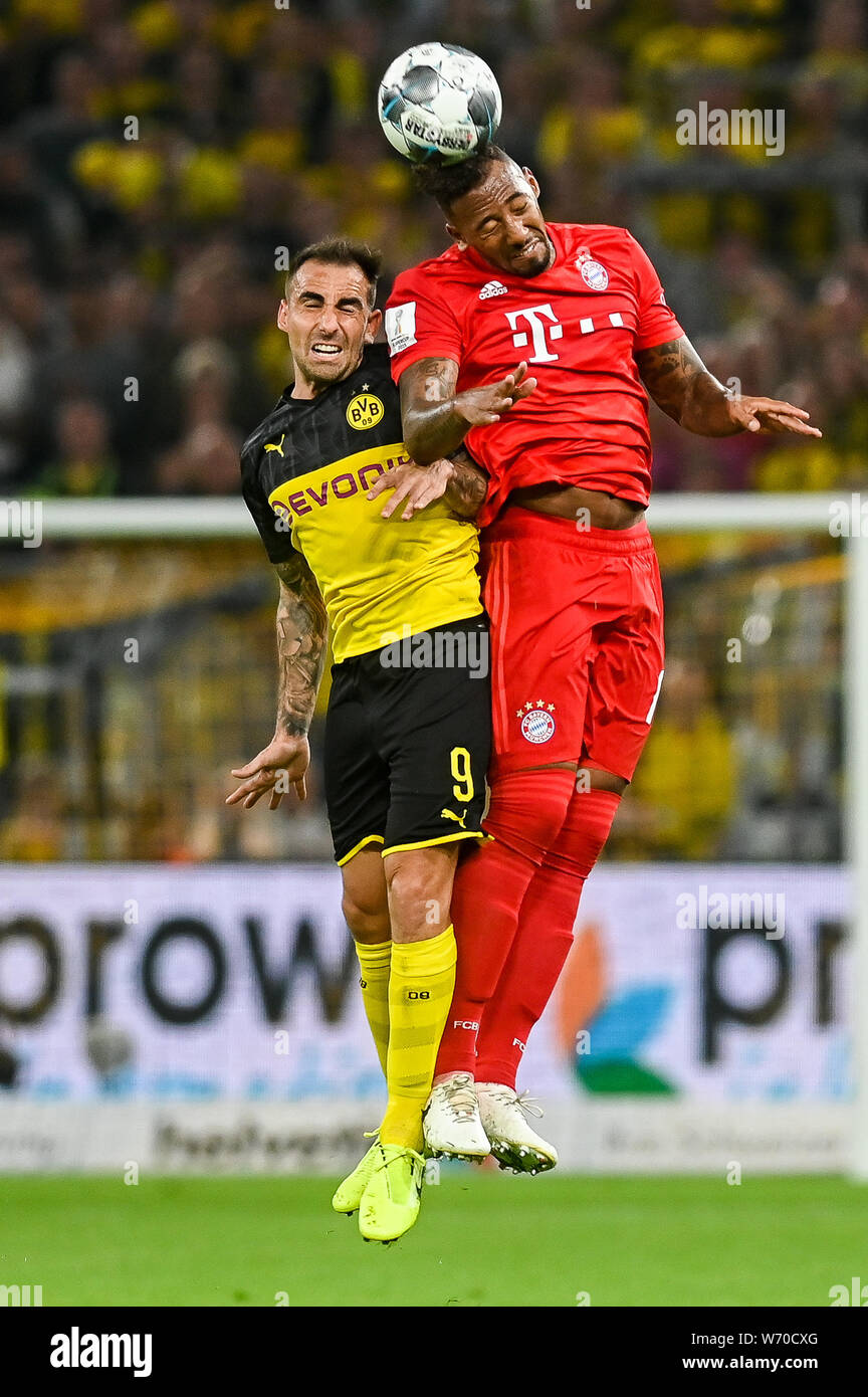 Paco Alcacer from Borussia Dortmund  (L) and Jerome Boateng from Bayern Munich (R) are seen in action during the Germany Supercup Final 2019 match between Borussia Dortmund and Bayern Munich.(Final score: Borussia Dortmund 2:0 Bayern Munich) Stock Photo
