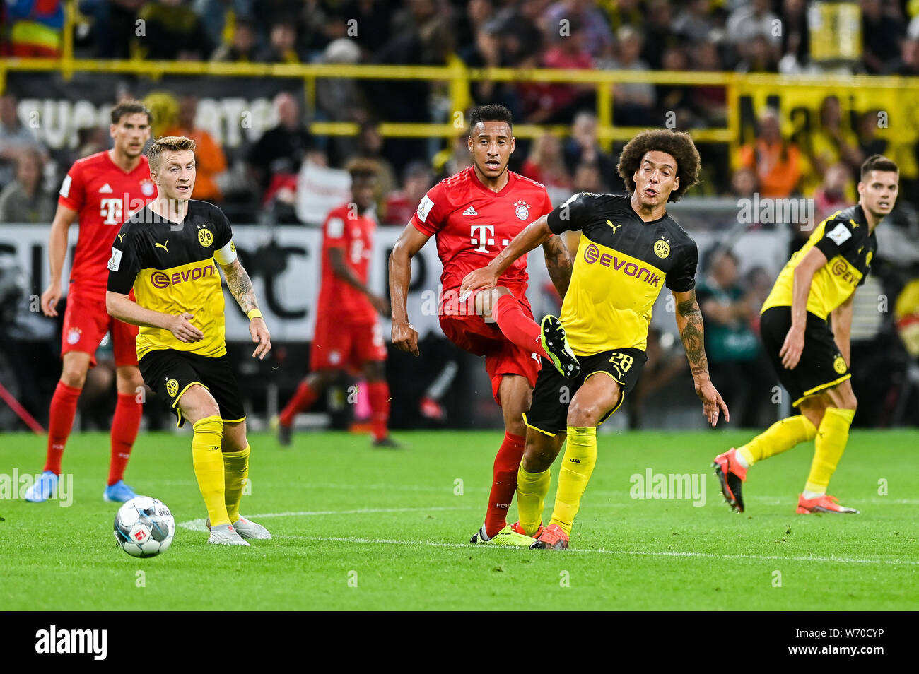 Marco Reus from Borussia Dortmund (L) Corentin Tolisso from Bayern Munich (C) and Axel Witsel from Borussia Dortmund (R) are seen in action during the Germany Supercup Final 2019 match between Borussia Dortmund and Bayern Munich.(Final score: Borussia Dortmund 2:0 Bayern Munich) Stock Photo