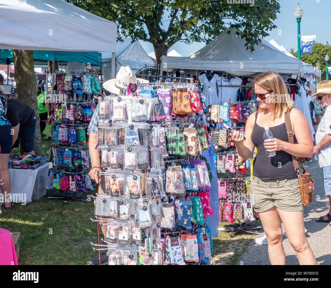 Shoppers check out the offerings at a vendor booth at Kempenfest in Barrie Ontario Canada. Stock Photo