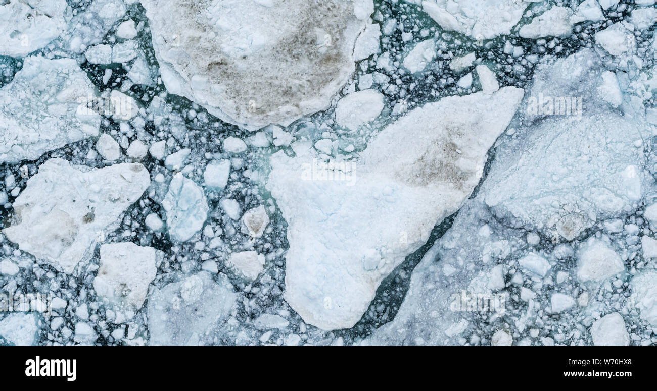 Icebergs drone aerial image top view - Climate Change and Global Warming. Icebergs from melting glacier in icefjord in Ilulissat, Greenland. Arctic nature ice landscape in Unesco World Heritage Site. Stock Photo