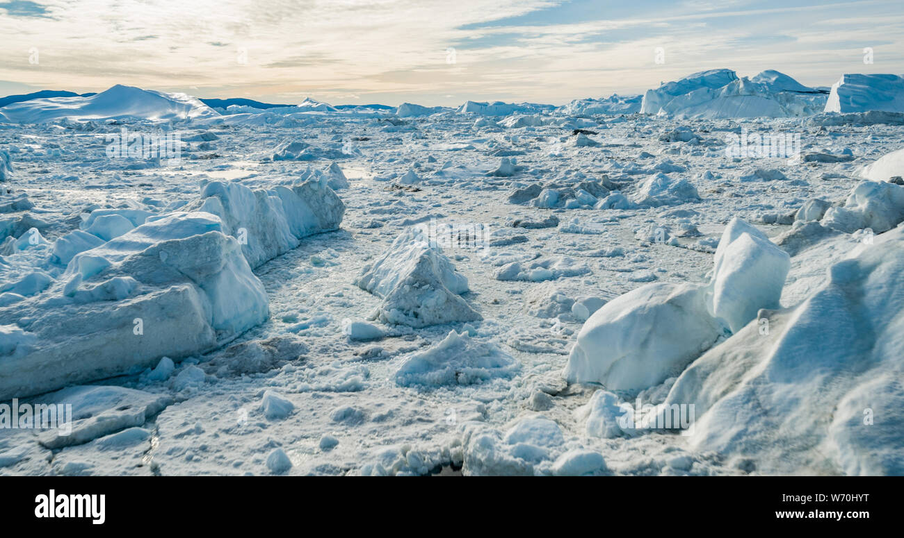 Global Warming and Climate Change - Icebergs from melting glacier in icefjord in Ilulissat, Greenland. Aerial image of arctic nature iceberg and ice landscape. Unesco World Heritage Site. Stock Photo