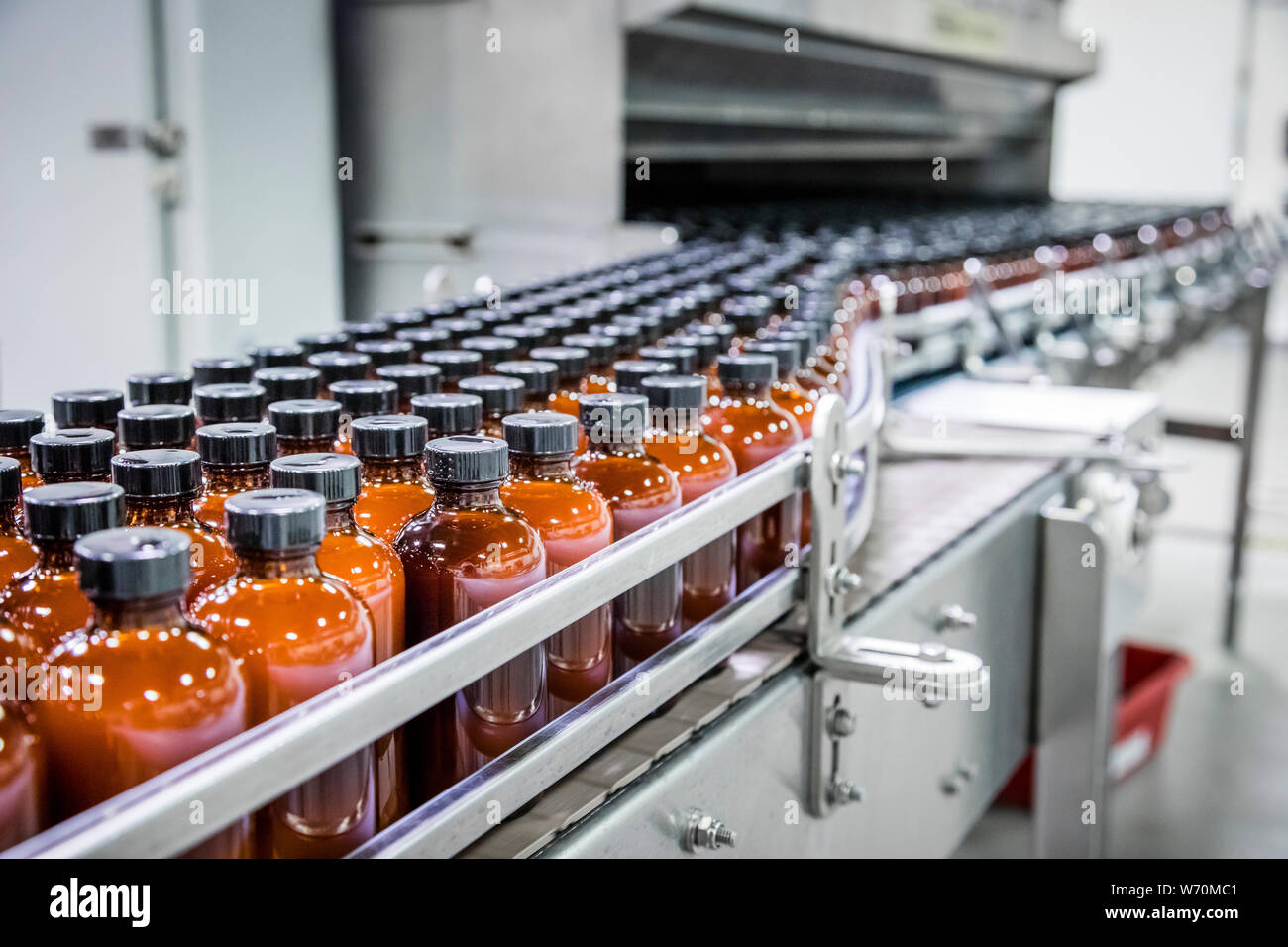 brown glass bottles in production line on conveyor Stock Photo