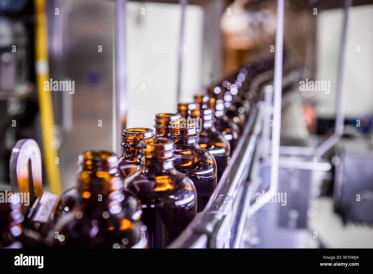 brown glass bottles in production line on conveyor Stock Photo Alamy
