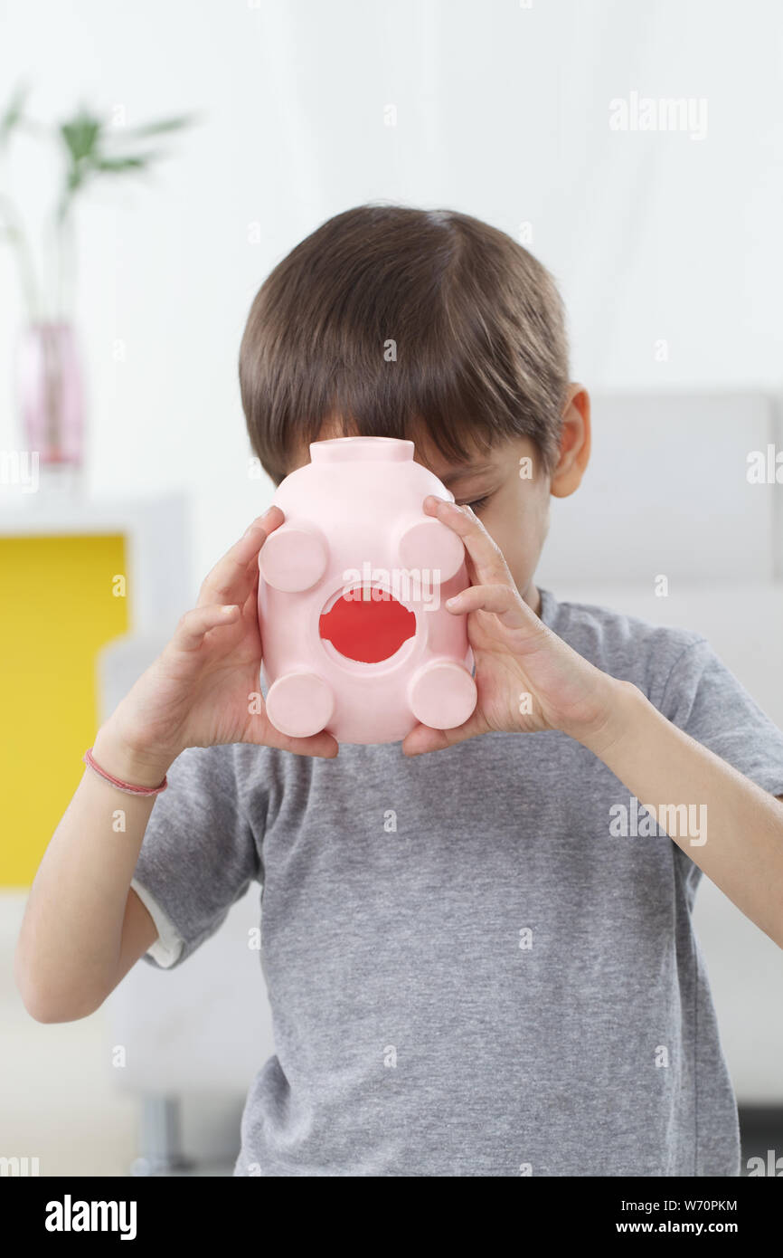 Boy holding a piggy bank Stock Photo - Alamy