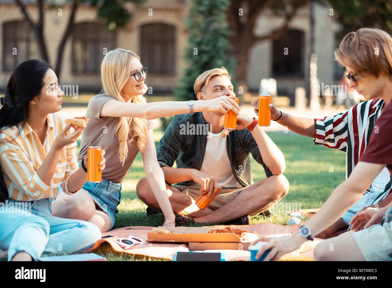 Students drinking juice and eating celebrating their graduation. Stock Photo