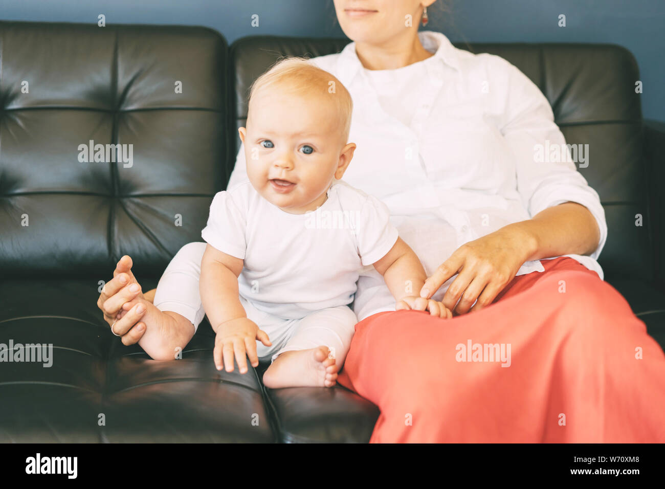 mother with baby on the couch Stock Photo