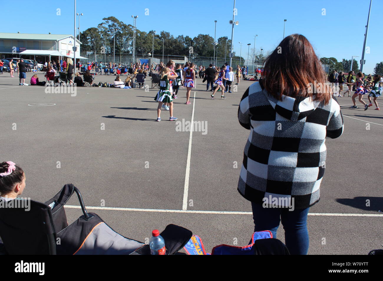 Parent watching children play sport Stock Photo
