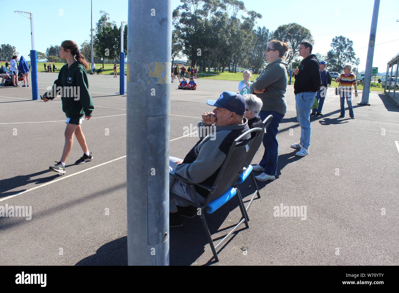 Parents and Grandparents watching children play netball Stock Photo