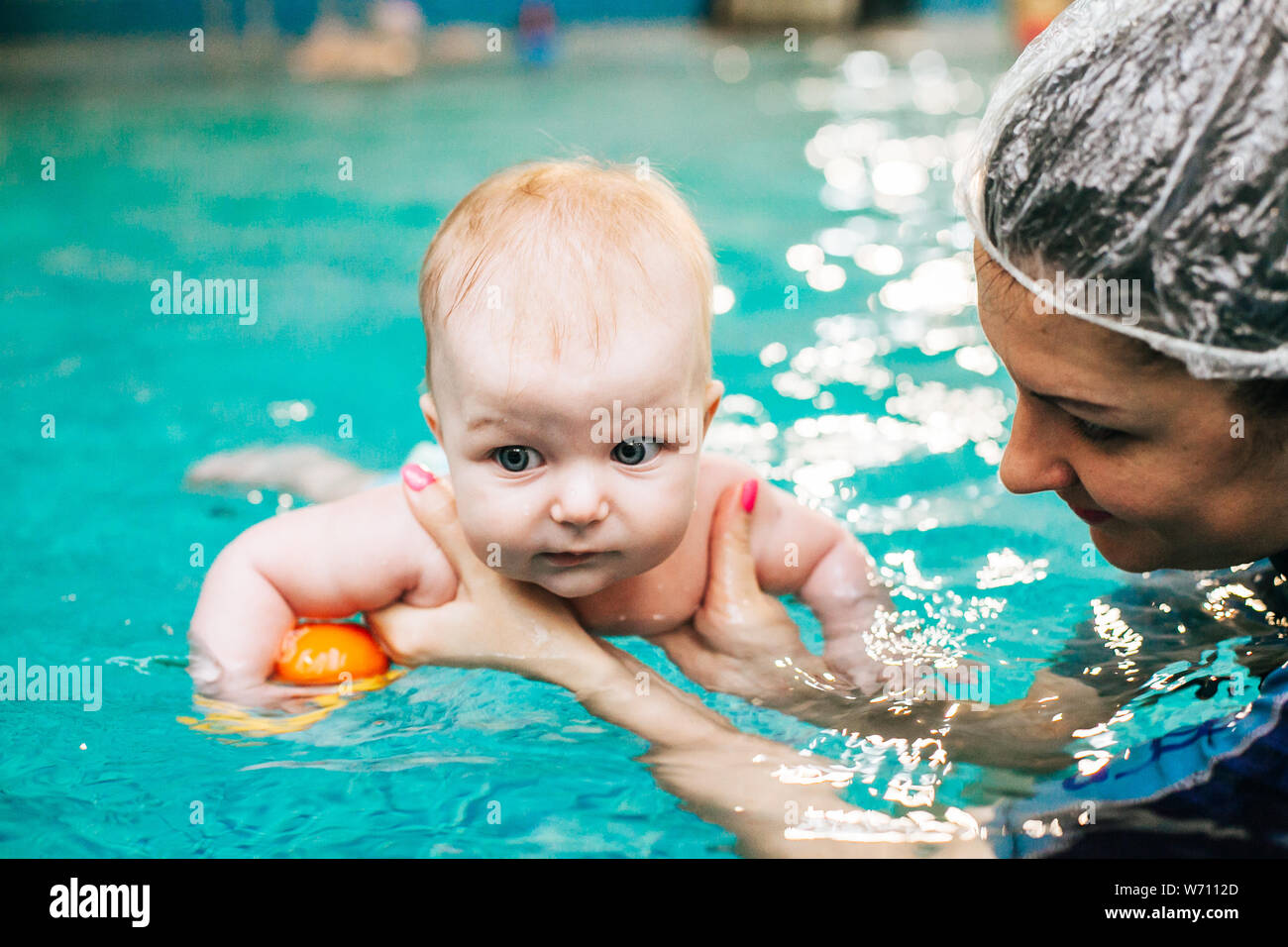 Baby entering swimming pool Stock Photo Alamy