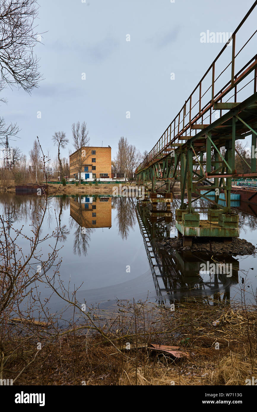 The abandoned river port in Pripyat. Abandoned ships in the river near