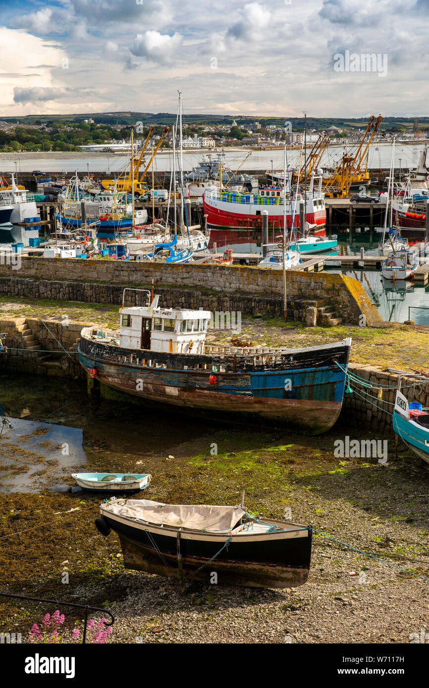 UK, England, Cornwall, Newlyn, Harbour, Old Quay old derelict boatt moored at low tide Stock Photo