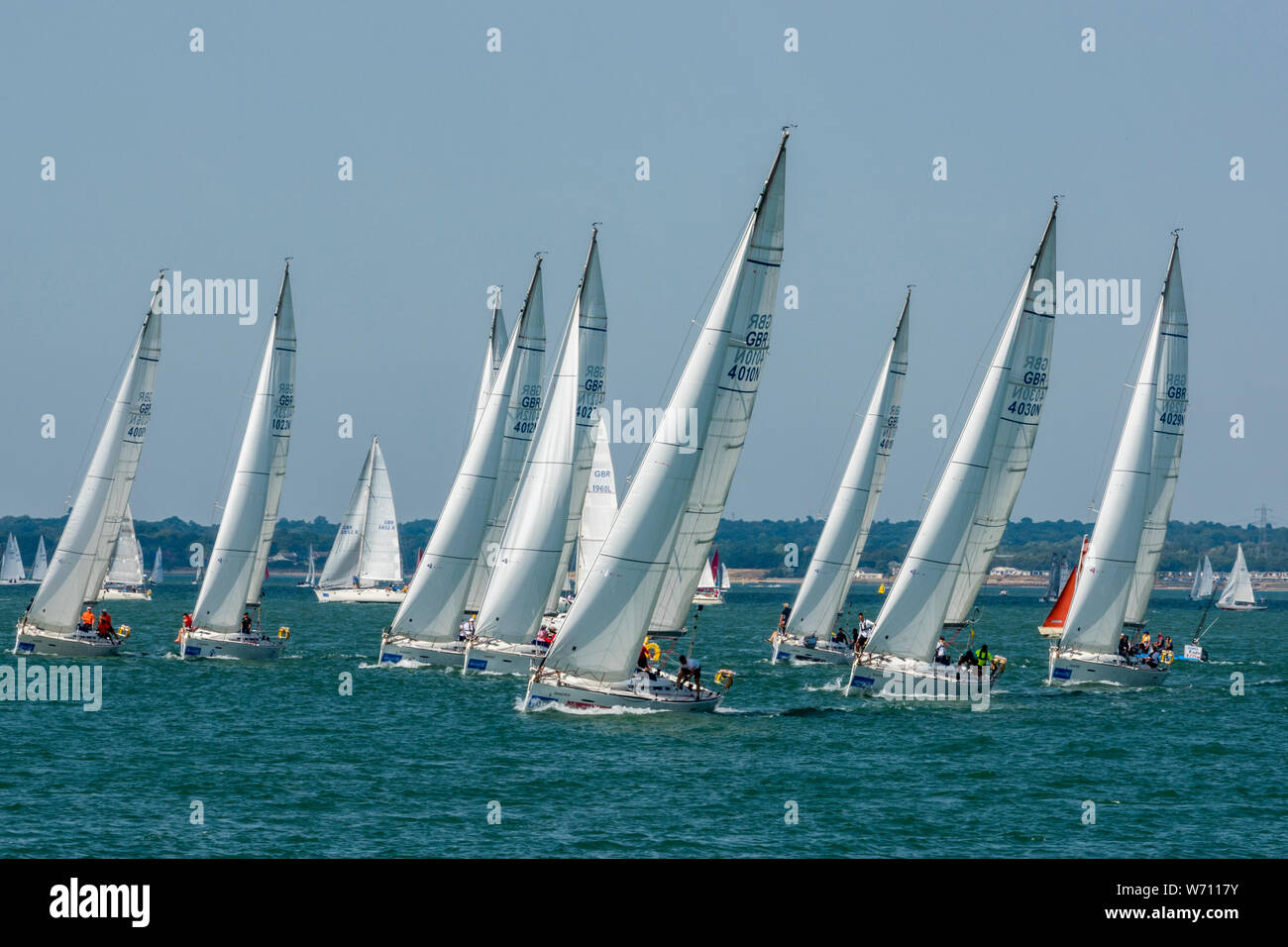 yachts racing in a fleet off of cowes on the isle of wight at the