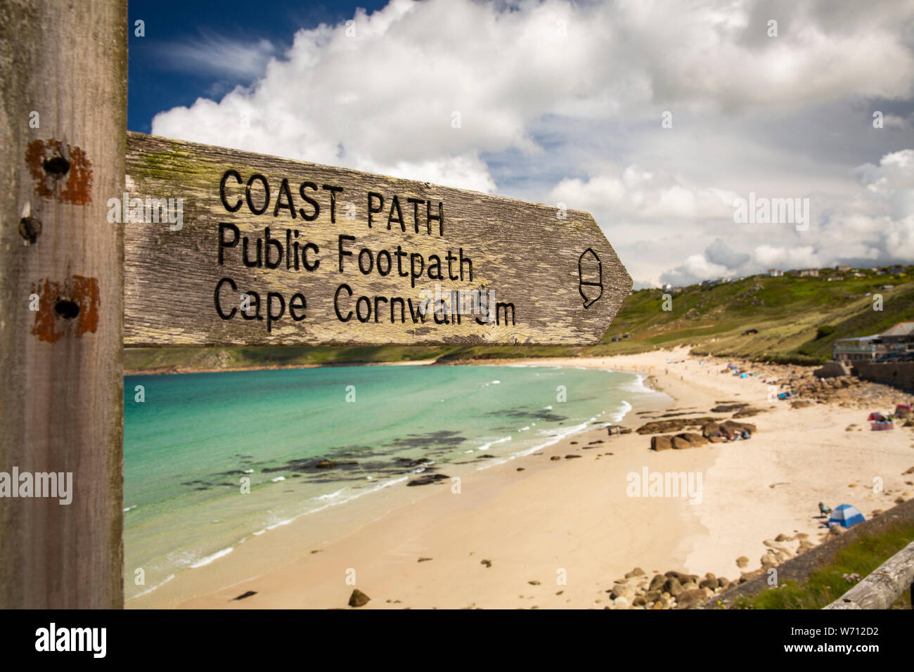 UK, England, Cornwall, Sennen Cove, Coast Path signpost to Cape Cornwall above beach in sunshine Stock Photo