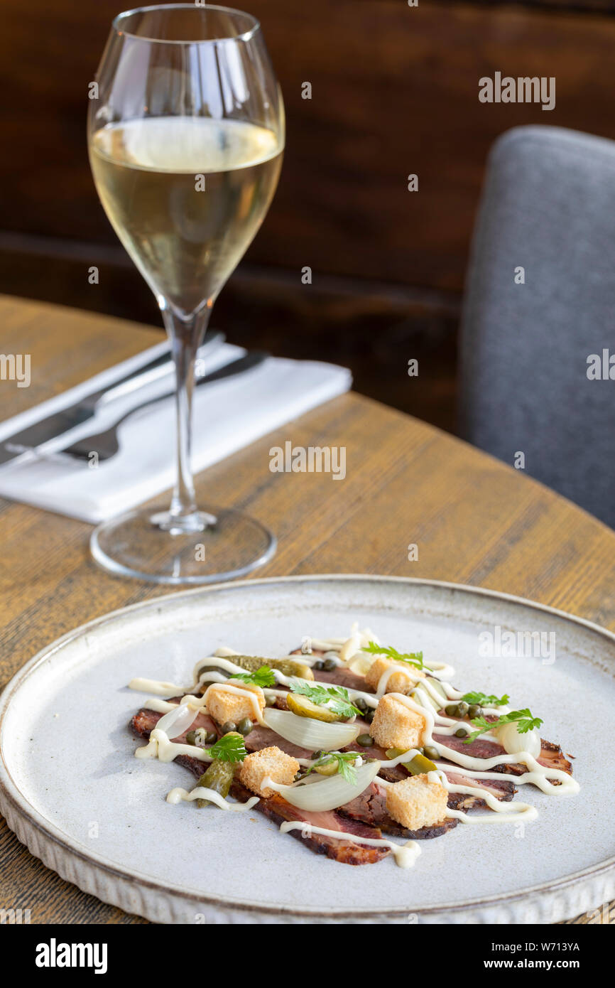 starter at restaurant with thinly sliced beef, croutons, shallot Stock