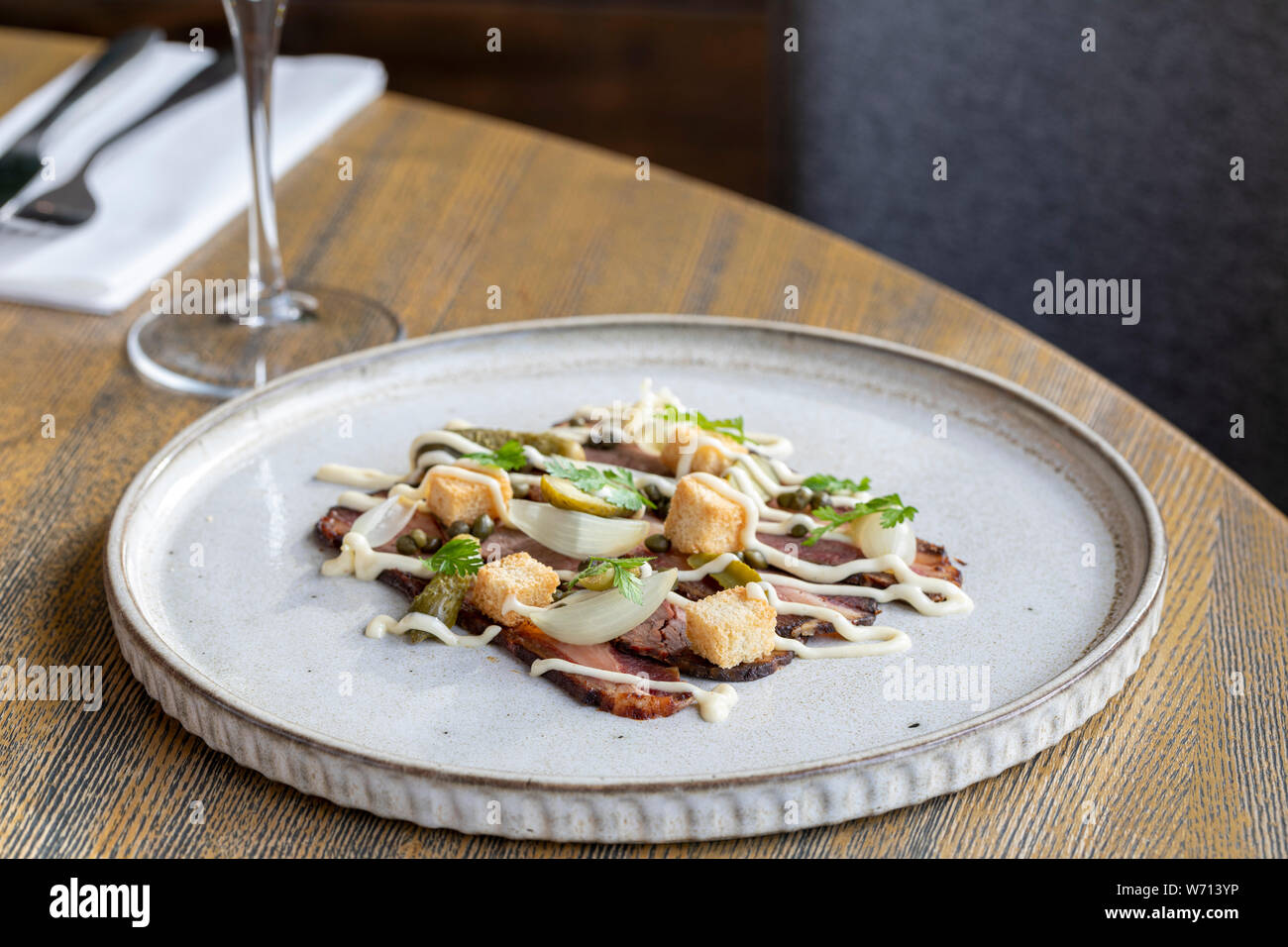 starter at restaurant with thinly sliced beef, croutons, shallot Stock