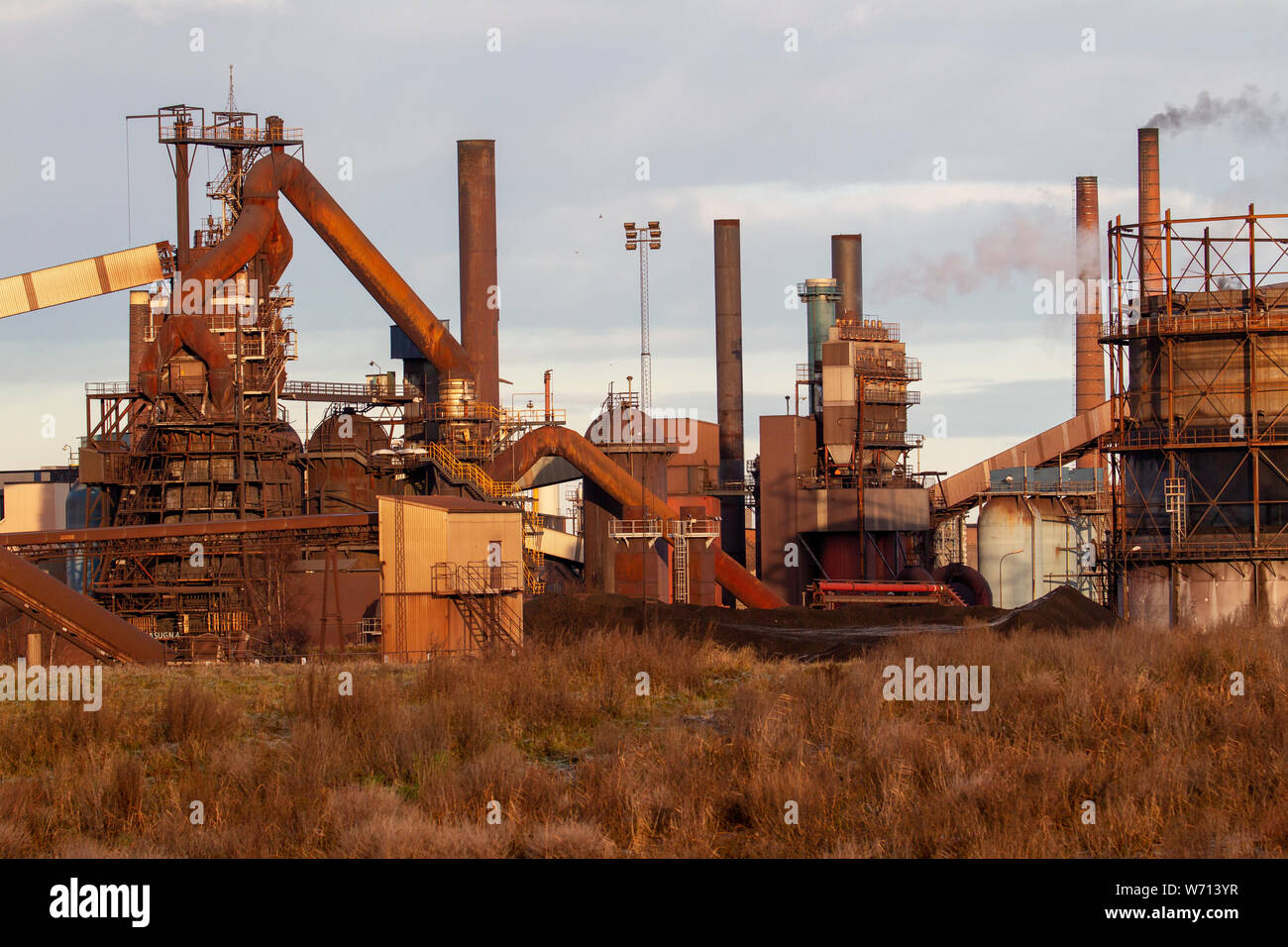 Pictures of a dirty steel plant with smoky chimneys Stock Photo