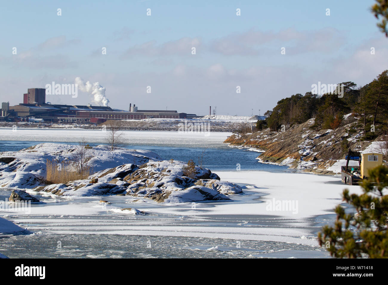 Winter landscape with a steel mill in the background Stock Photo
