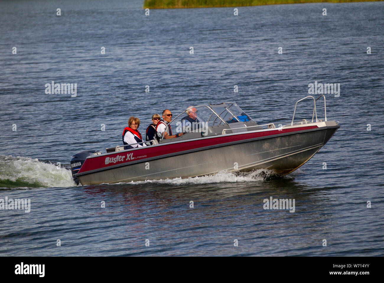 Many people in an aluminum boat in a Swedish lake Stock Photo