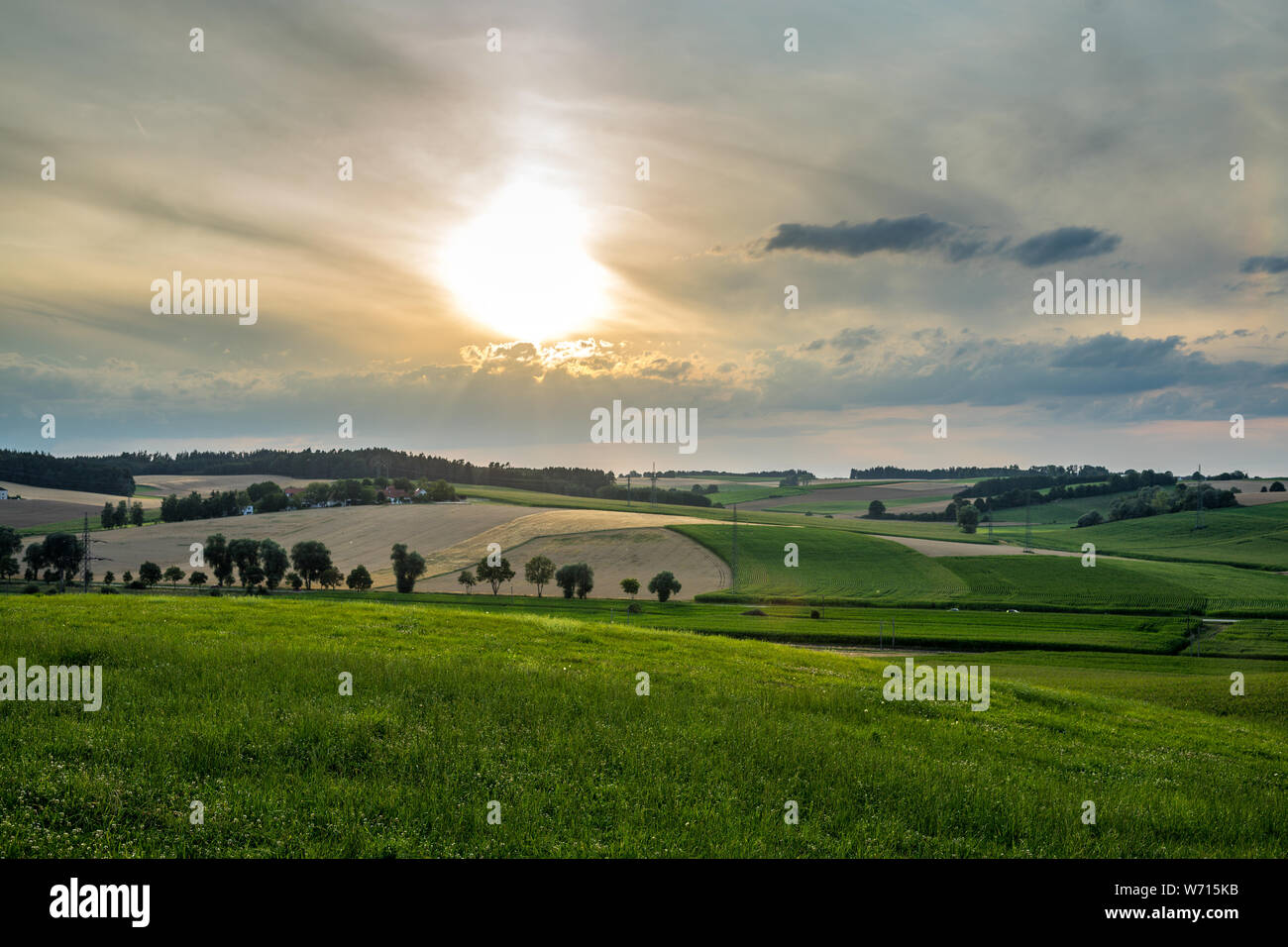 Hilly landscape in bavaria with sunny dramatic sky Stock Photo