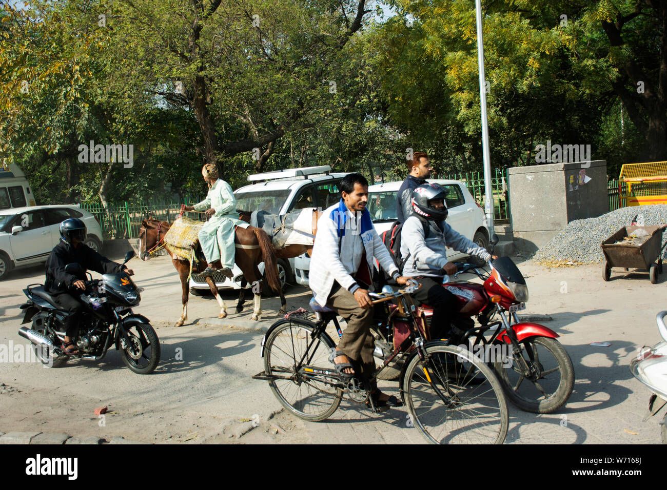 Indian people and foreigners drive car and ride motorcycle and bike