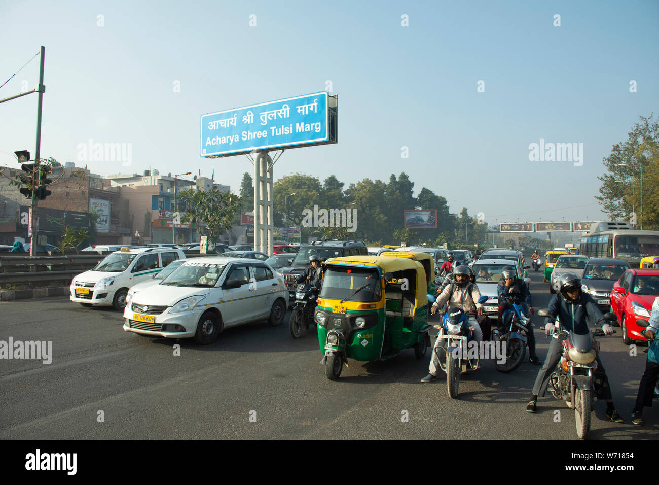 Indian people and foreigners drive car and ride motorcycle and bike