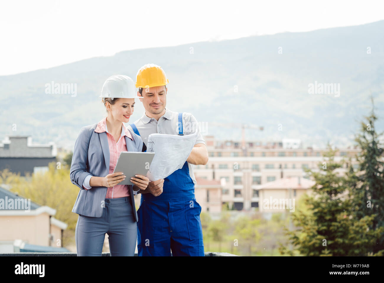 Architect and builder developing ideas for construction project Stock ...