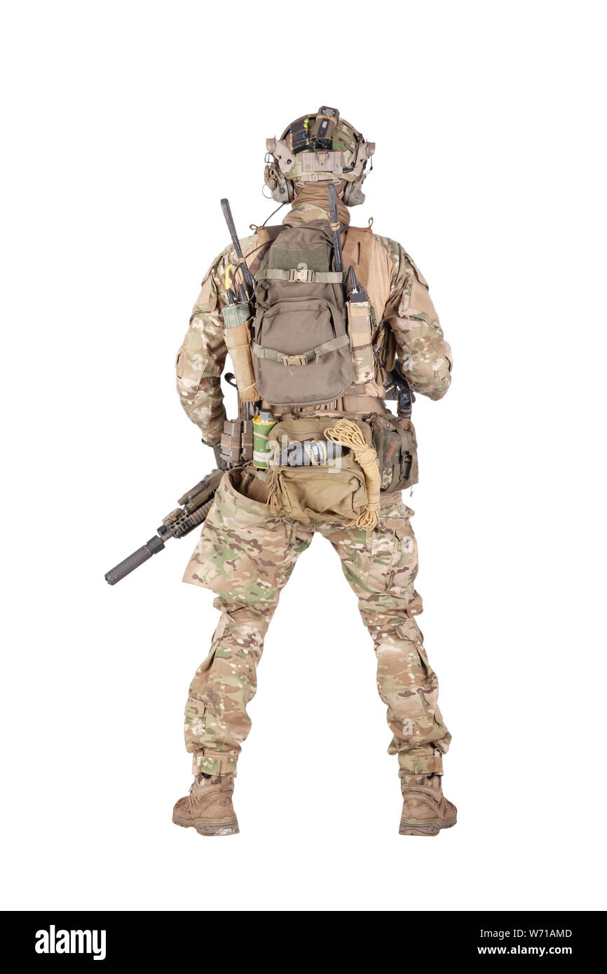 Army soldier in camo uniform and battle helmet, equipped tactical radio