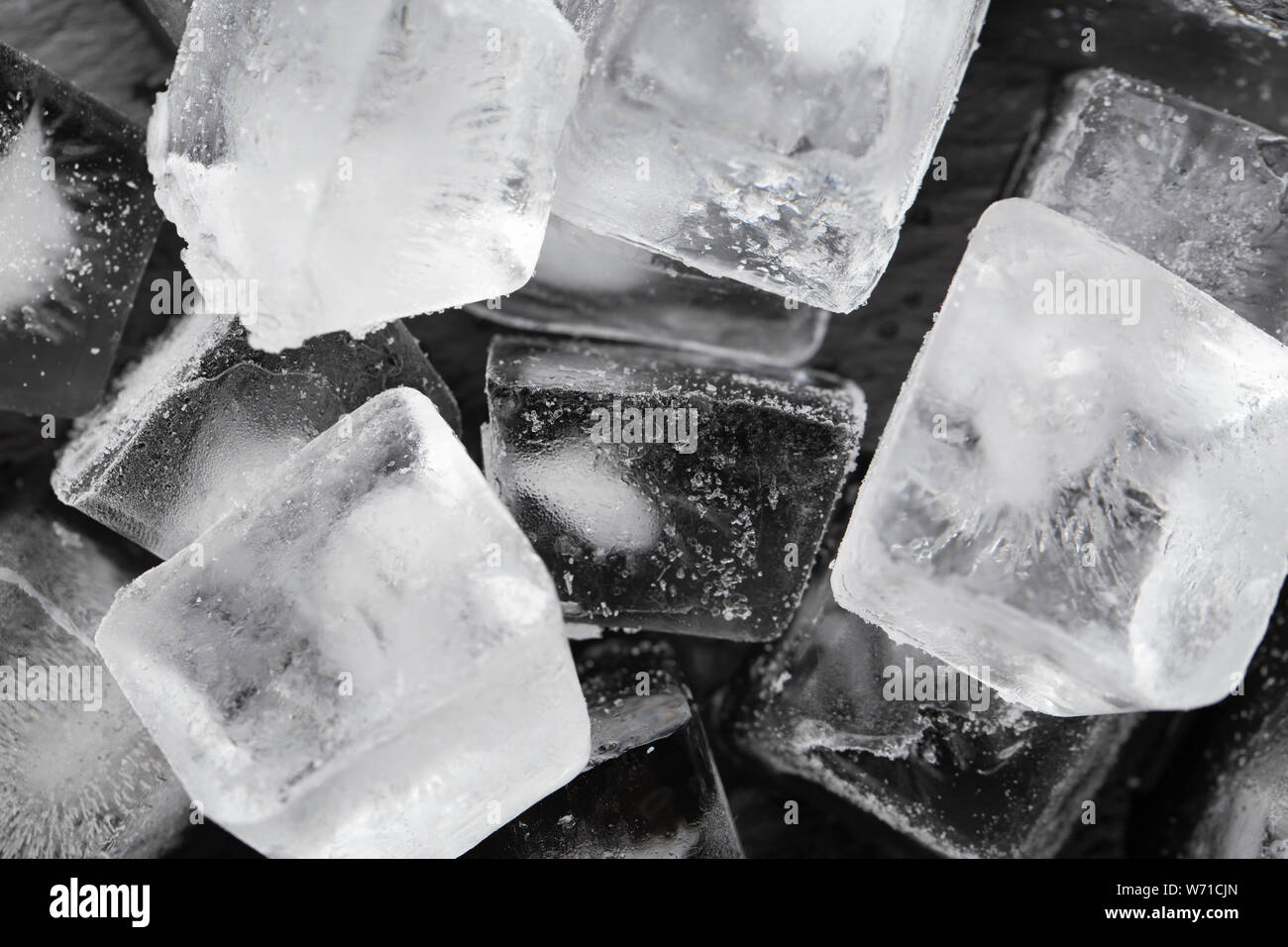 Ice cubes on a black background. View from above Stock Photo - Alamy