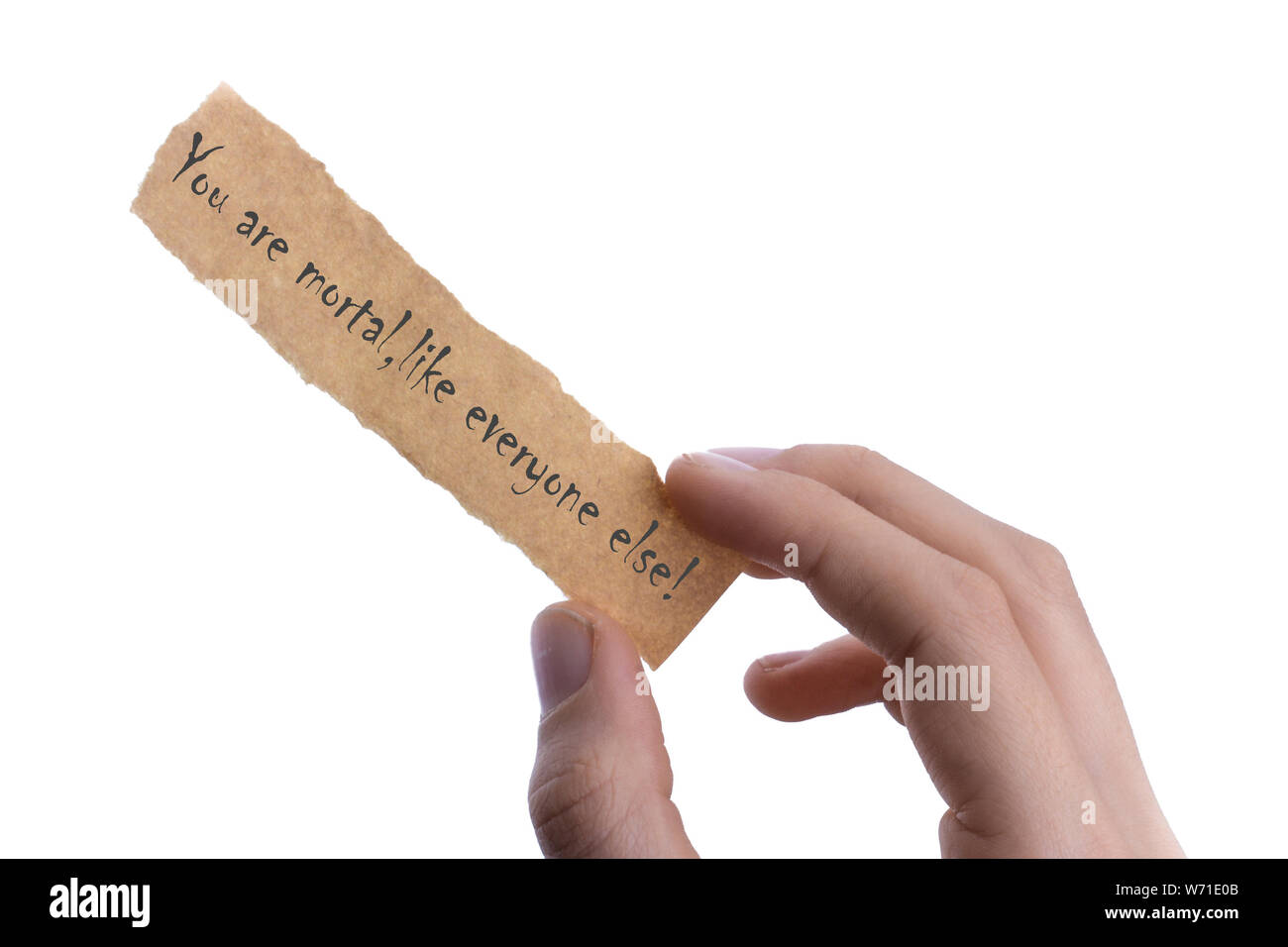 hand holding  piece of blank torn notepaper says YOU ARE MORTAL Stock Photo