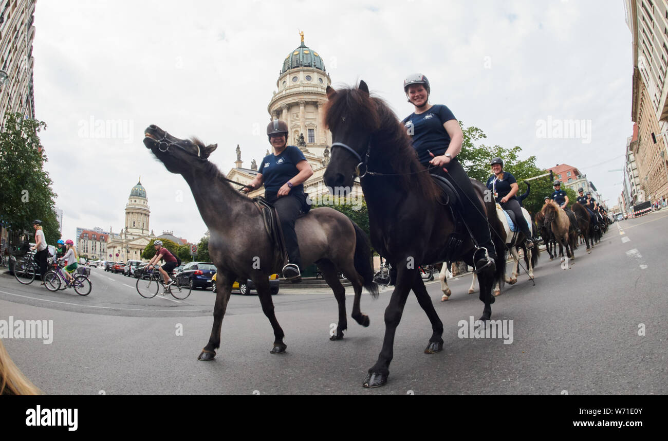 Berlin, Germany. 04th Aug, 2019. Athletes ride their Icelandic horses past the Gendarmenmarkt. The Icelandic World Horse Championships 2019 begin with a ride through the city from the Victory Column to the Karlshorst World Championships Stadium. Credit: Annette Riedl/dpa/Alamy Live News Stock Photo