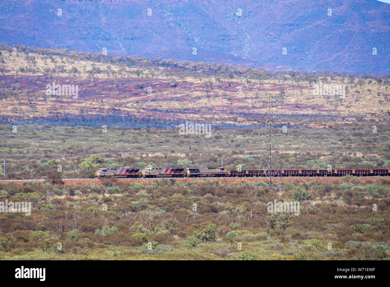 Long train at Karijini National Park transporting iron ore from Marandoo mine site towards next port Stock Photo