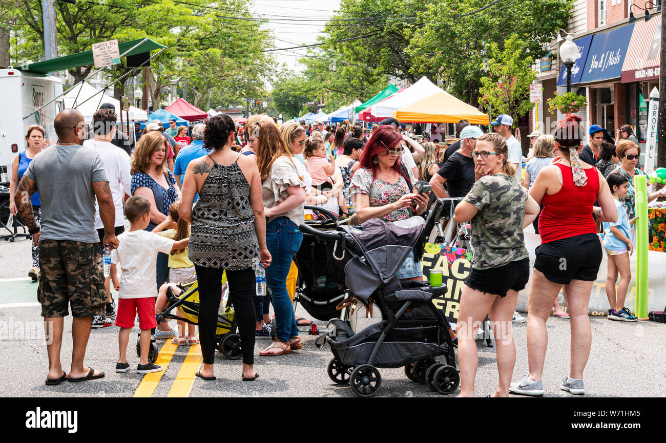 Babylon, New York, USA - 1 June 2019: Crowds of people are talking and walking in the streets during the first street fair of the season in Babylon, N Stock Photo