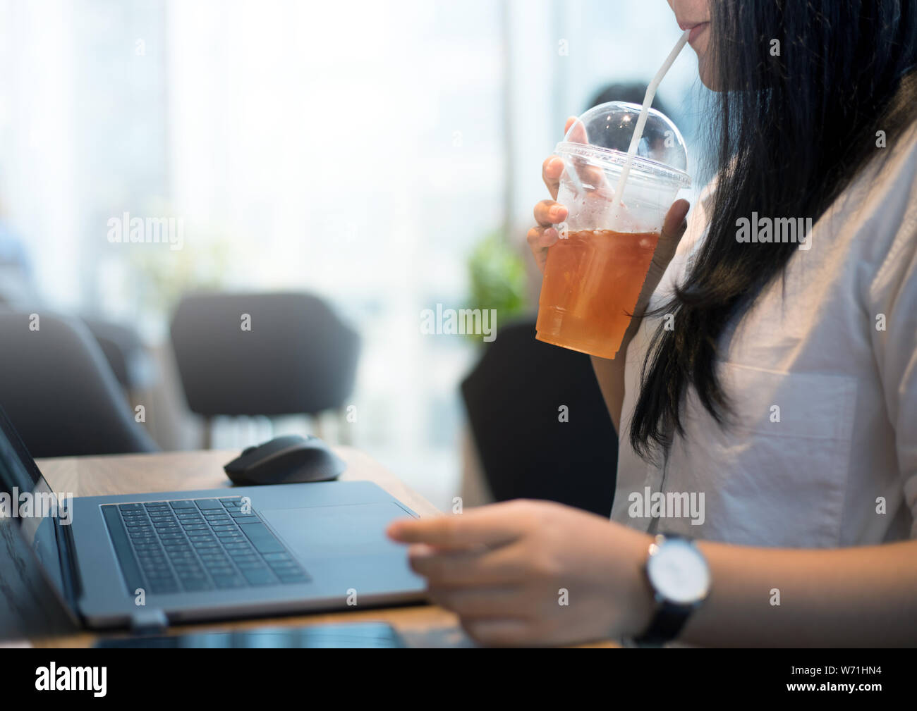 Young woman on work with drinking tea for refreshment Stock Photo