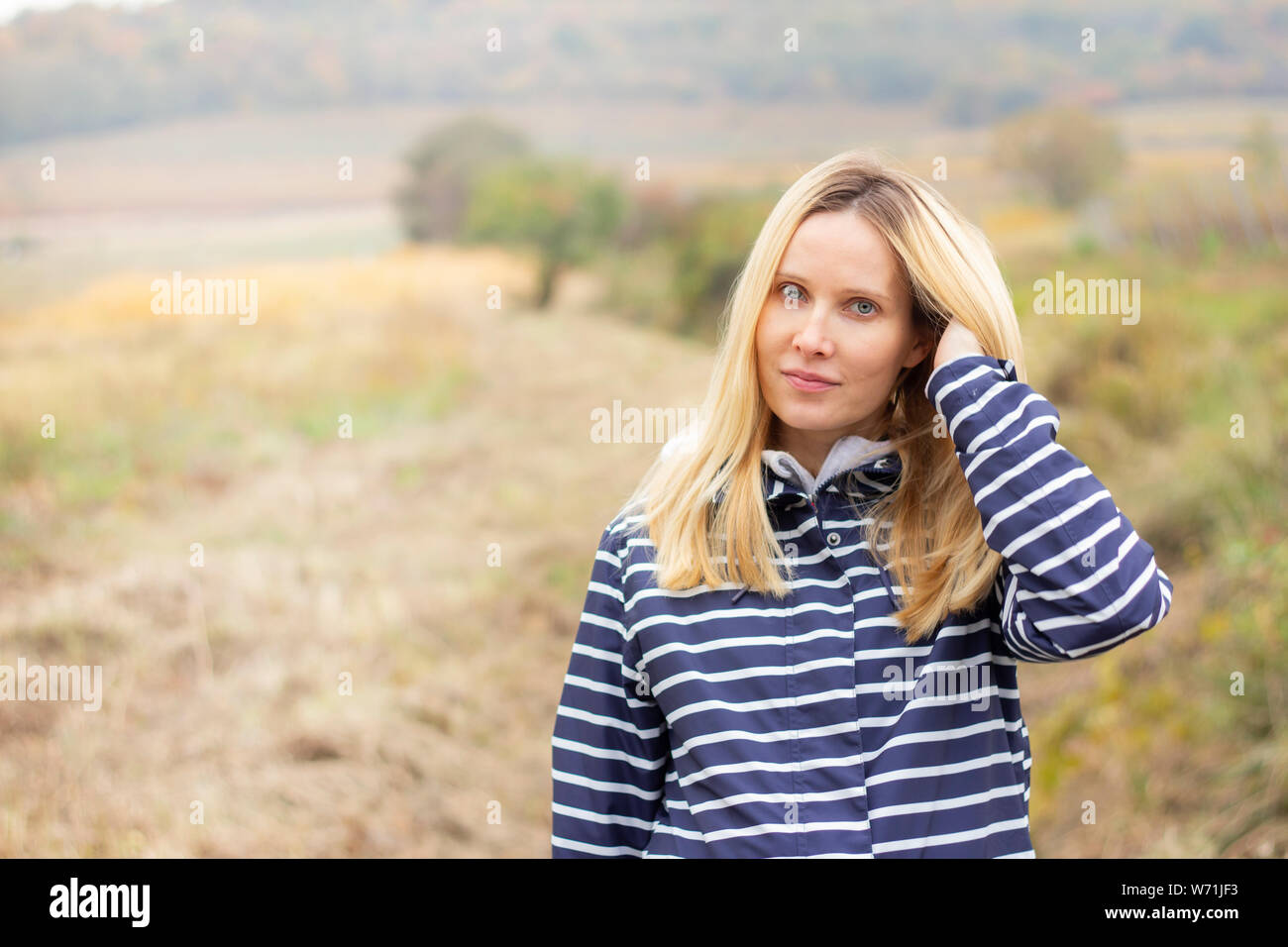 portrait of attractive blonde woman on meadow Stock Photo