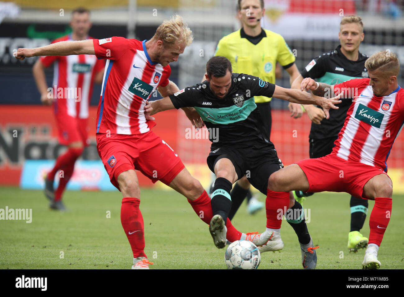 Heidenheim, Germany. 04th Aug, 2019. Soccer: 2nd Bundesliga, 1st FC Heidenheim - VfB Stuttgart, 2nd matchday, in the Voith Arena. Sebastian Griesbeck (l) and Niklas Dorsch (r) from Heidenheim fight with Gonzalo Castro from Stuttgart for the ball. Credit: Daniel Karmann/dpa - IMPORTANT NOTE: In accordance with the requirements of the DFL Deutsche Fußball Liga or the DFB Deutscher Fußball-Bund, it is prohibited to use or have used photographs taken in the stadium and/or the match in the form of sequence images and/or video-like photo sequences./dpa/Alamy Live News Stock Photo
